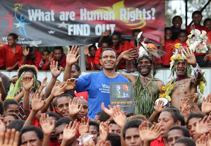 Augustine Brian (in blue) is bringing human rights to life for the people of the Southern Highlands province of Papua New Guinea.
