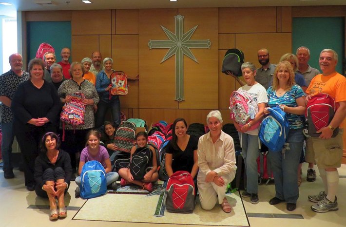 Volunteers from Interfaith Ministries of Greater Queen Anne at a luncheon at the Church of Scientology Seattle, where they prepared backpacks and school supplies to donate to local underserved children. 