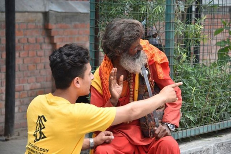 Scientology Volunteer Minister provides an assist to a Hindu devotee in Kathmandu