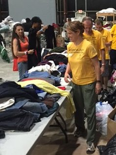 Volunteers help sort donated clothing for those in need.