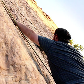 Scientologist Dallas Hunter rock climbing, medium shot