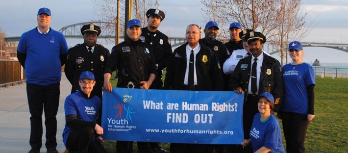 Members of the Buffalo Special Police and the Buffalo chapter of Youth for Human Rights gather at the Peace Bridge April 16, 2017, to watch the bridge lit in the BPS’s colors to symbolize their commitment to human rights education.