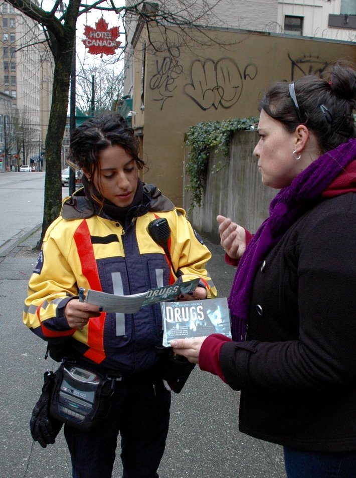 Volunteer hands out copies of The Truth About Drugs as part of a drug prevention workshop at the Church of Scientology of Vancouver.