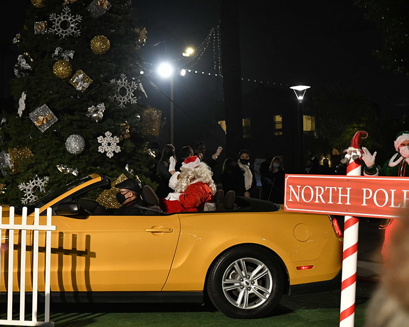 Santa arrived early in a yellow Mustang convertible to take part in the Holiday Lights celebration.
