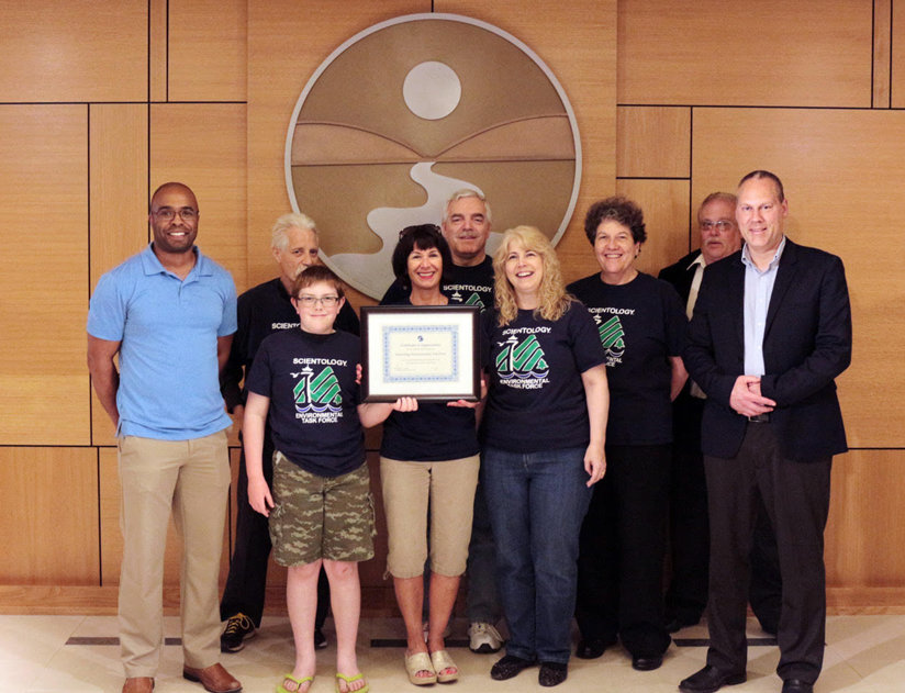 Senior Planning and Development Specialist with Seattle Public Utilities who oversees the City’s Adopt-a-Street program presents a special award to the Scientology Environmental Task Force.